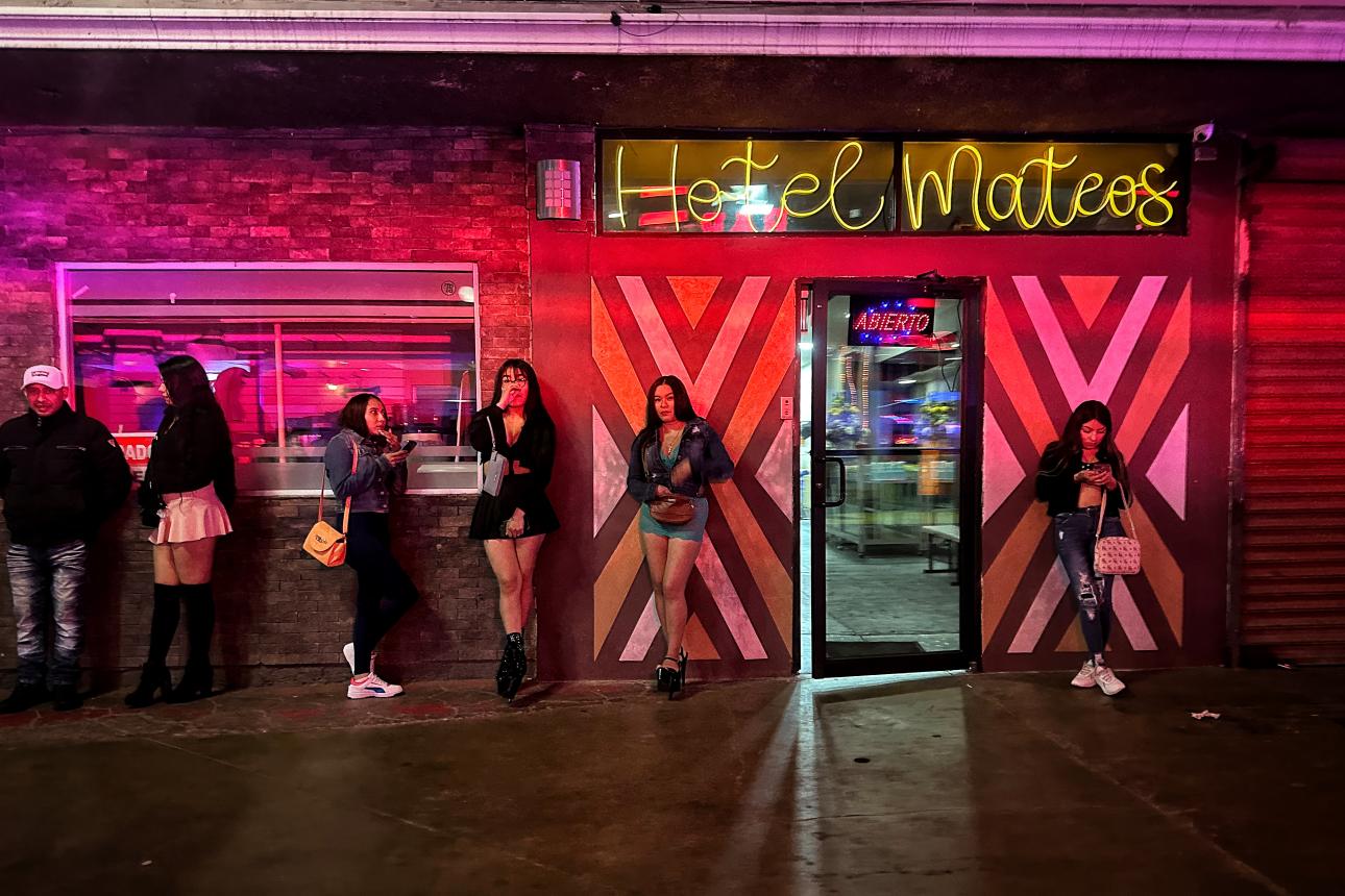 The rows of women leaning on the walls of the many “gentlemen clubs” and bars in the huge red-light district are an indication of how women are typically viewed in this macho society / Christopher Cunningham
